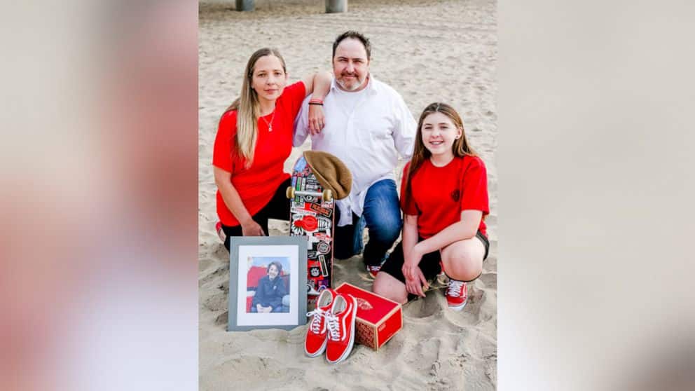 A photo of a father, mother, and their daughter at the beach